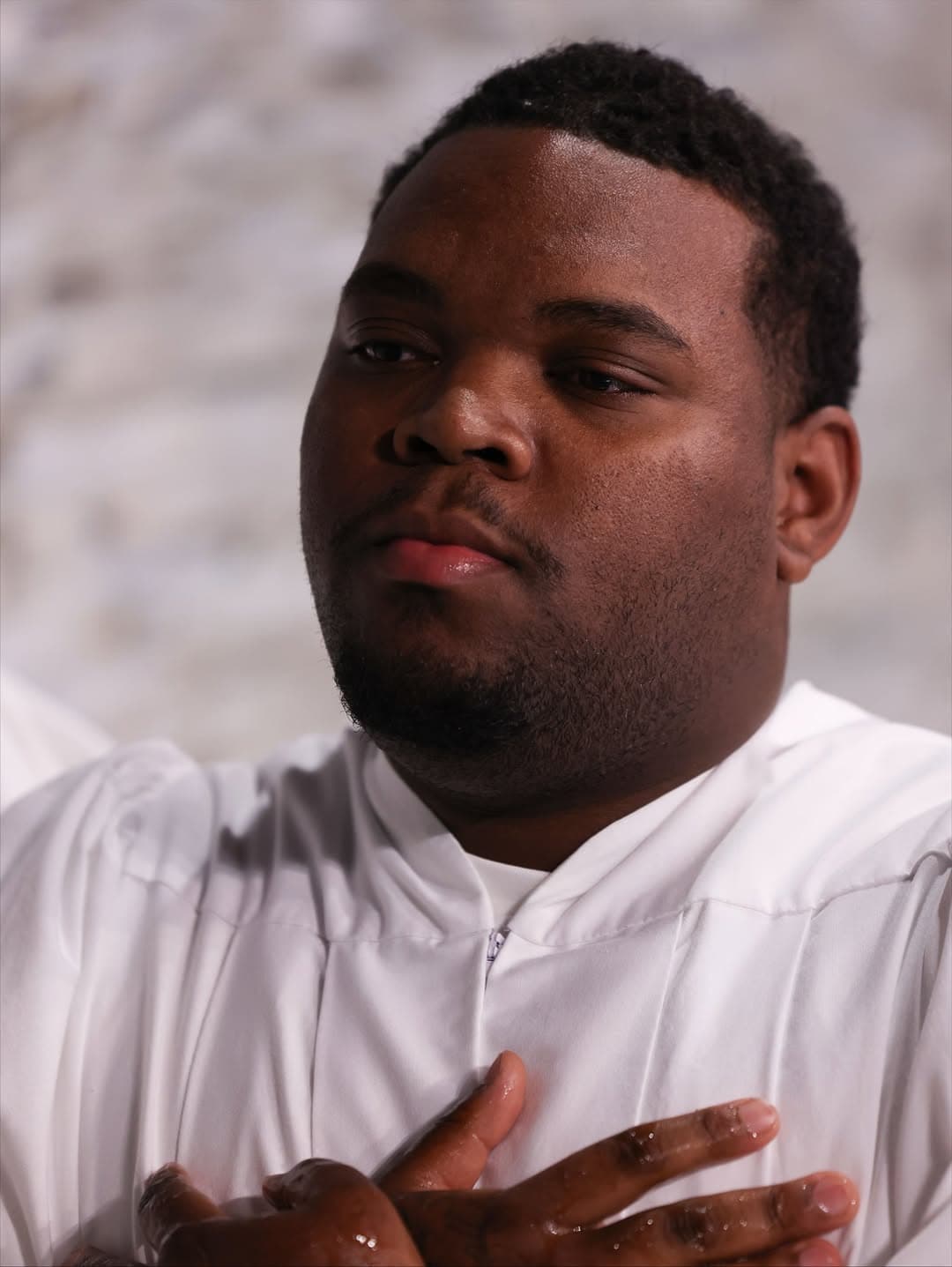 Young man reflecting on baptism